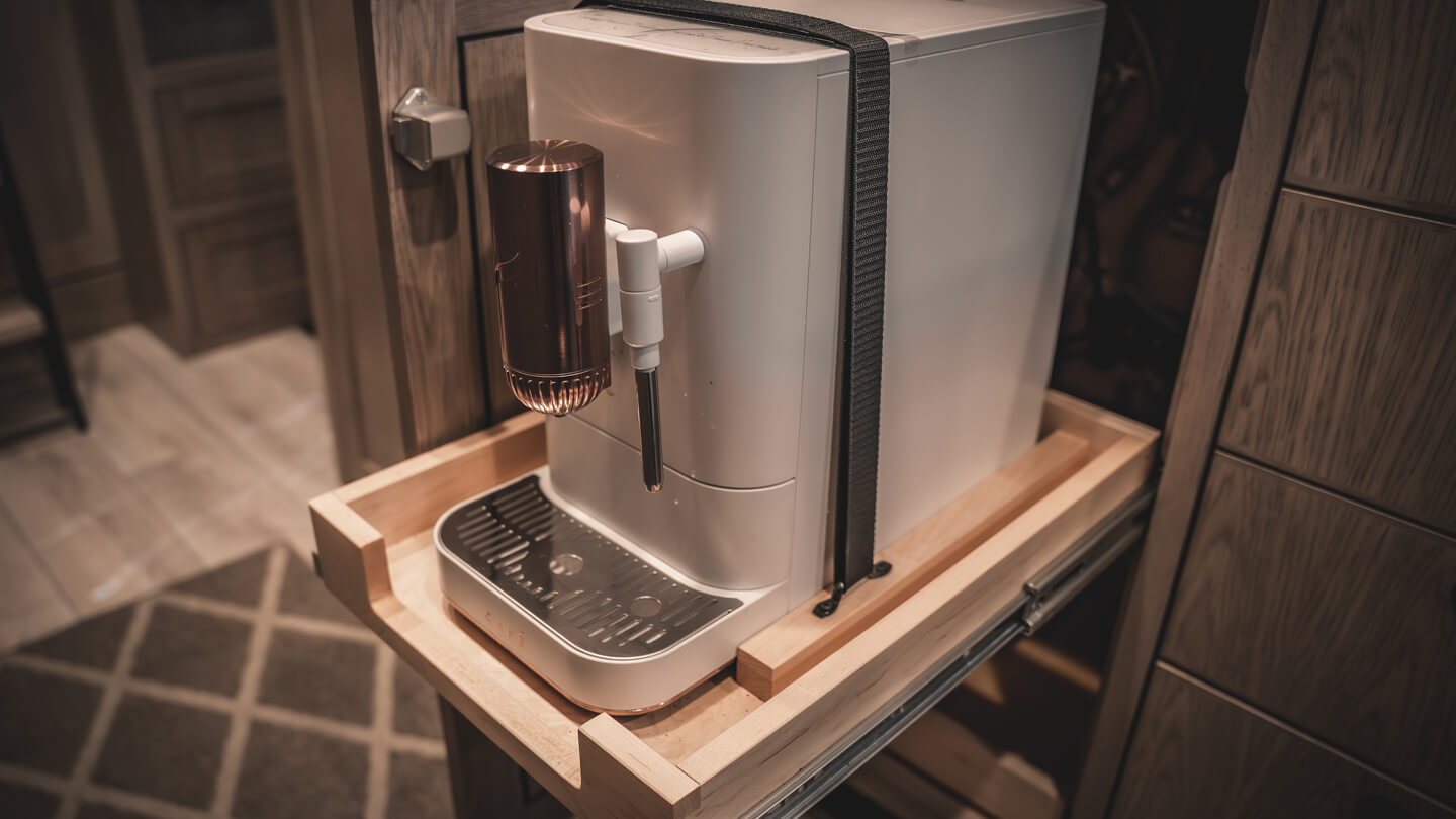Coffee machine on wooden shelf.