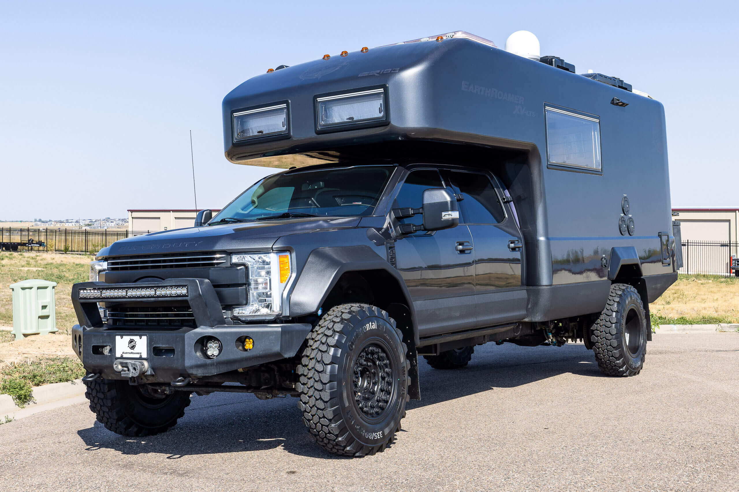 EarthRoamer XV-LTS expedition vehicle parked in the wilderness highlighting rugged off-road design.