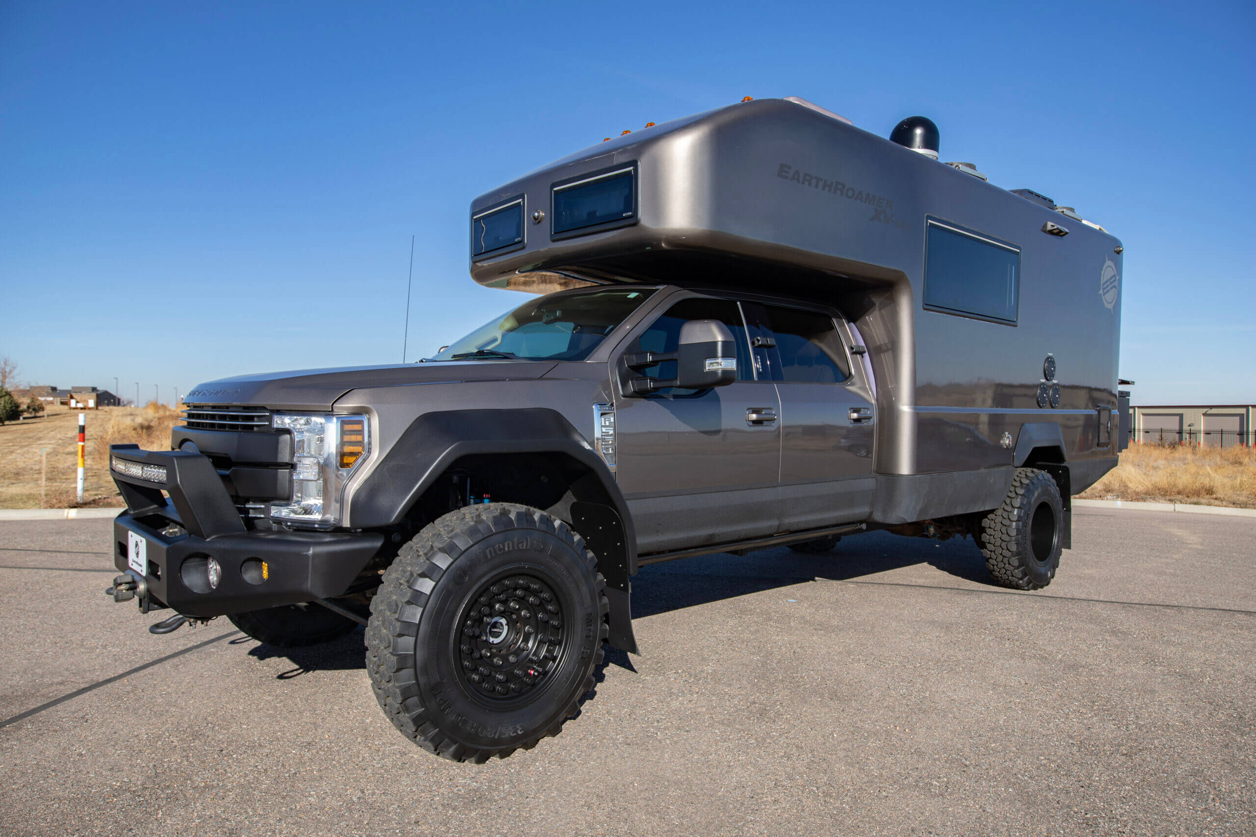 EarthRoamer XV-LTS kitchen featuring stainless steel appliances, sink, and modern cabinetry.