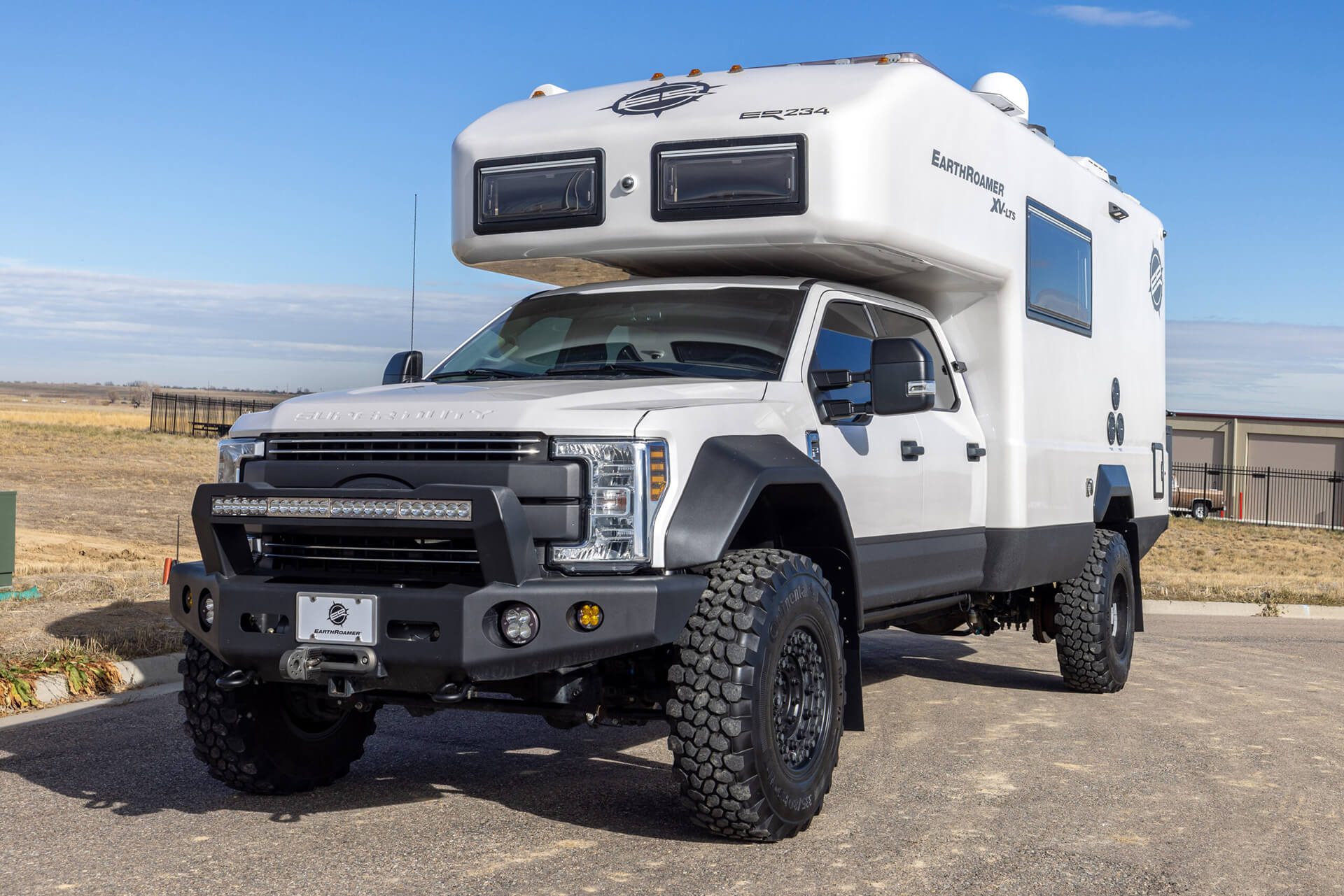 EarthRoamer XV-LTS interior dining and lounge area with wood finishes and LED lighting.