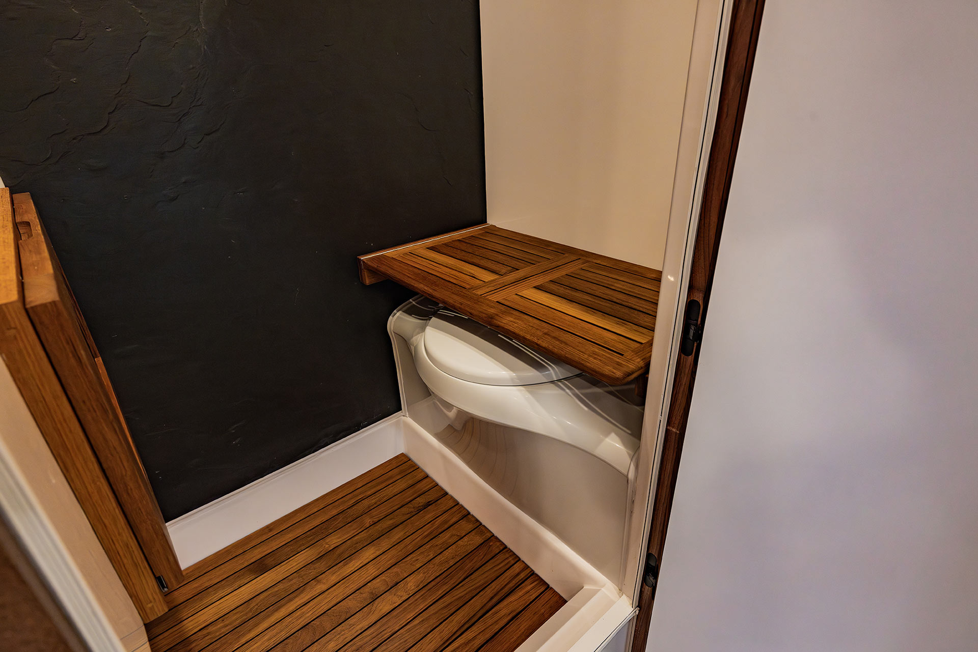 EarthRoamer illuminated wine storage cabinet with integrated glass holder and wood shelving.