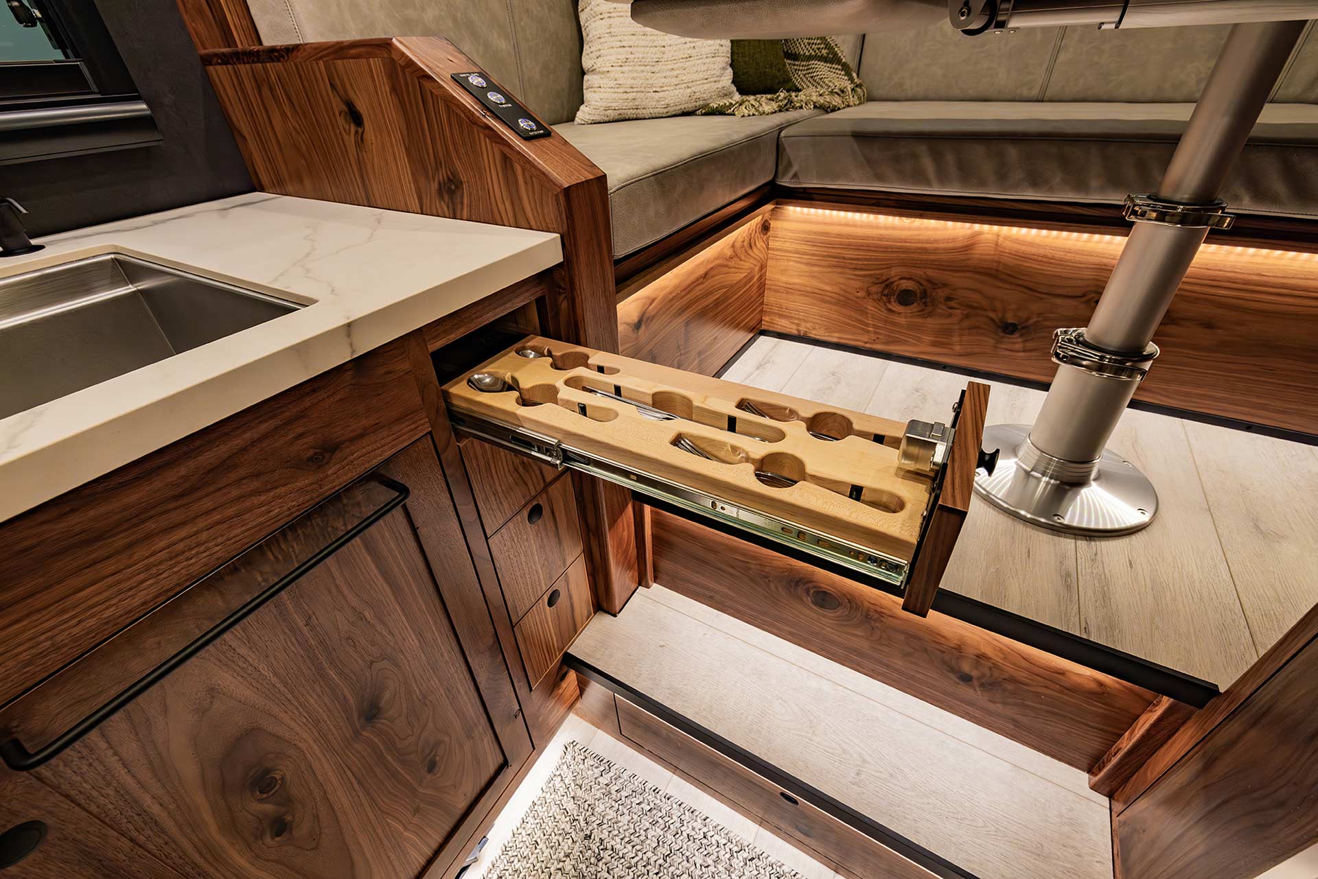 EarthRoamer luxury kitchen with wooden drawer showcasing custom utensil organizer.