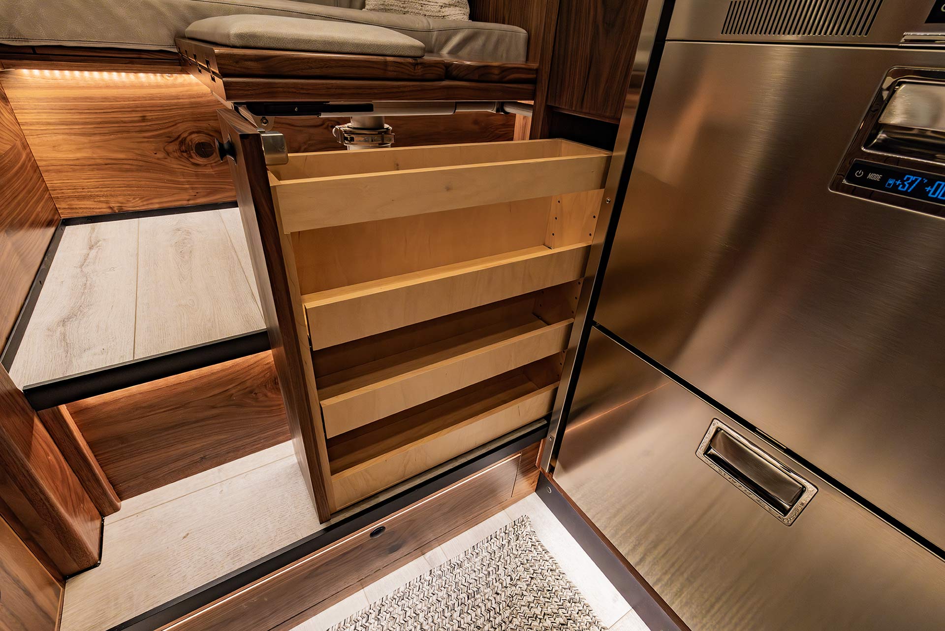 EarthRoamer pull-out pantry cabinet with multiple wooden shelves for storage.
