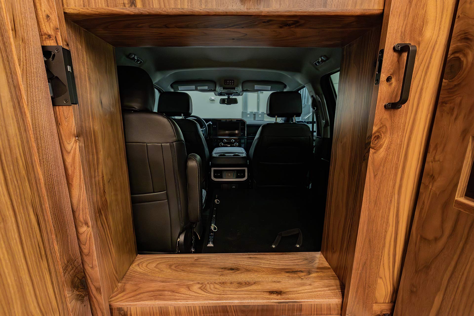 EarthRoamer cabin pass-through view from camper to truck driver’s cabin with leather seats.