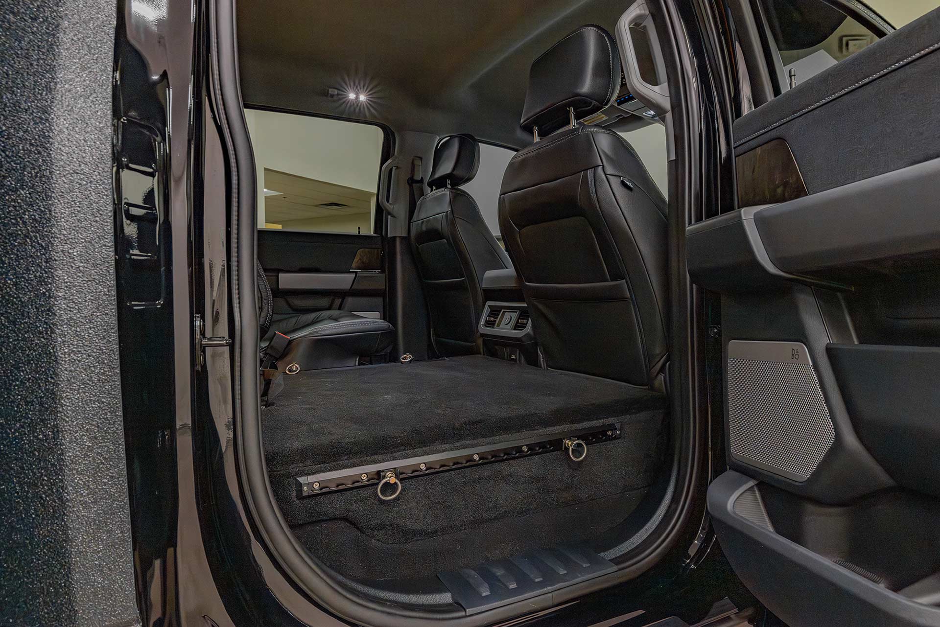EarthRoamer rear truck interior with folded-down back seats creating additional storage space.