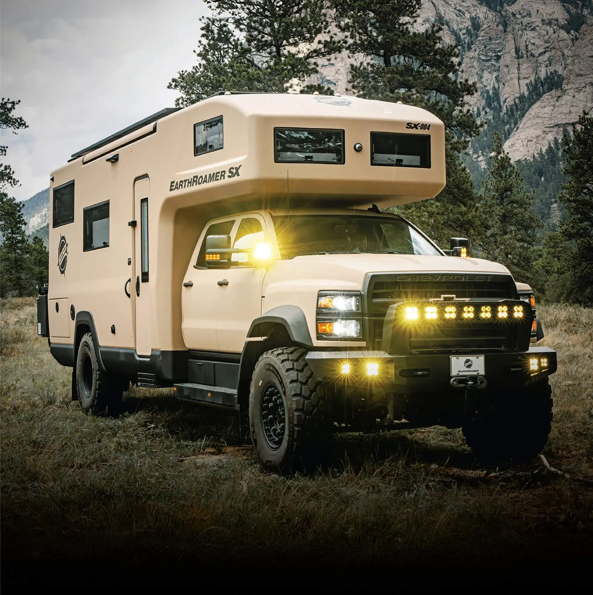 EarthRoamer SX luxury off-road expedition vehicle in beige color with LED lights on