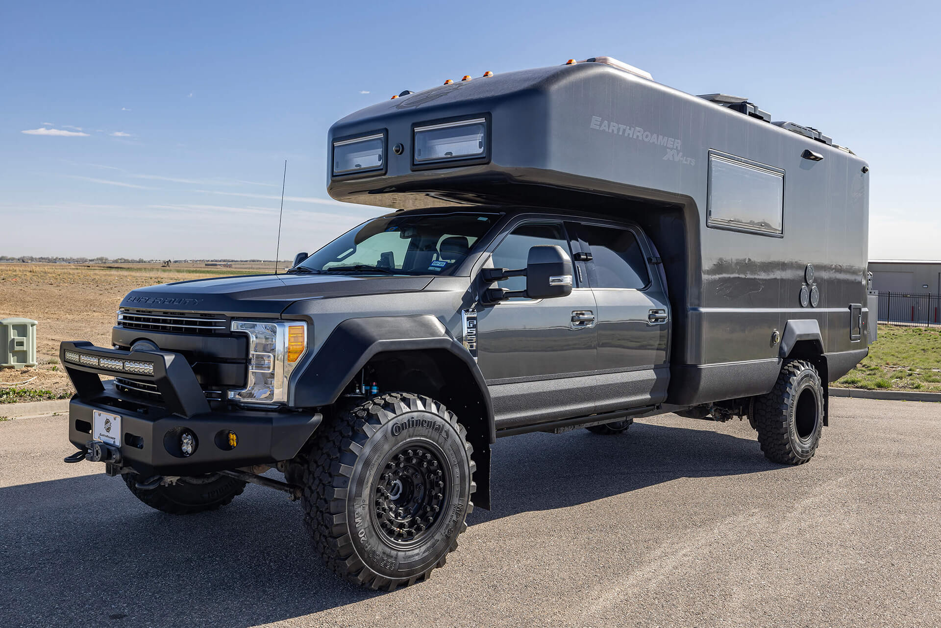 EarthRoamer luxury camper lounge with soft lighting, premium upholstery, and wooden accents.