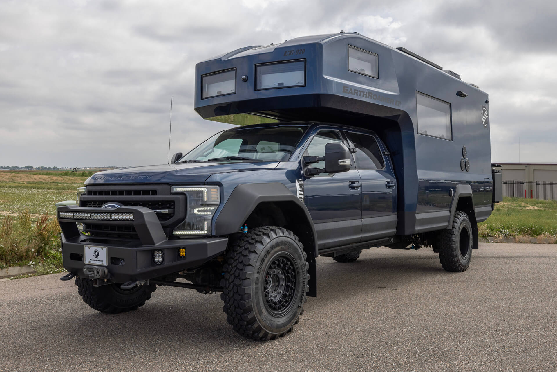 EarthRoamer luxury camper kitchen with induction cooktop, sink, and modern storage.